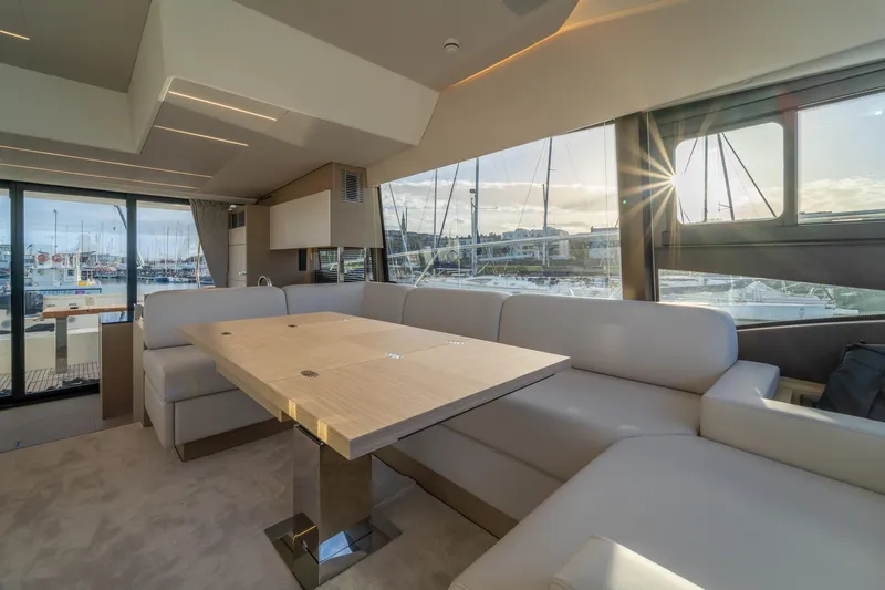  Yacht Photos Pics Luxurious interior of 2025 Prestige 520 yacht with elegant seating and marina view.