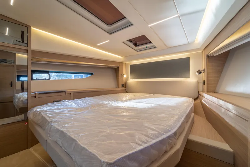  Yacht Photos Pics Luxurious interior of 2025 Prestige 520 yacht bedroom with modern design and ambient lighting.