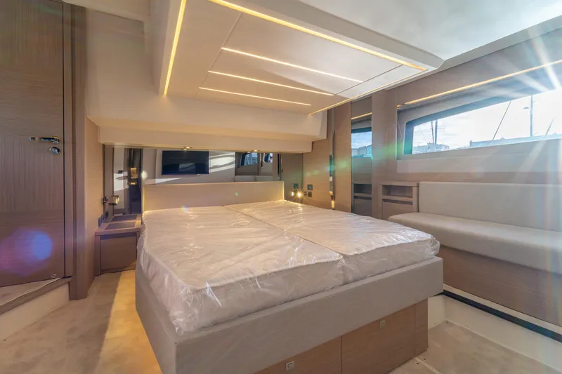  Yacht Photos Pics Luxurious interior of 2025 Prestige 520 yacht, featuring modern bedroom design and ambient lighting.