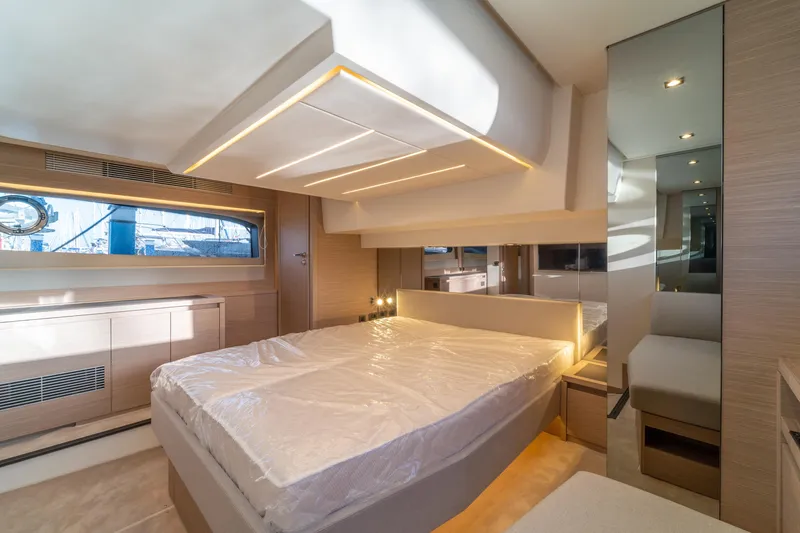  Yacht Photos Pics Luxurious interior of 2025 Prestige 520 yacht bedroom with modern design and ambient lighting.