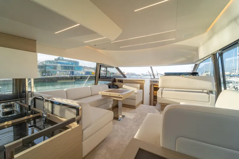  Yacht Photos Pics Luxurious interior of 2025 Prestige 520 yacht with modern furnishings and panoramic windows.