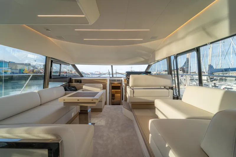  Yacht Photos Pics Luxurious interior of 2025 Prestige 520 yacht with elegant seating and panoramic windows.