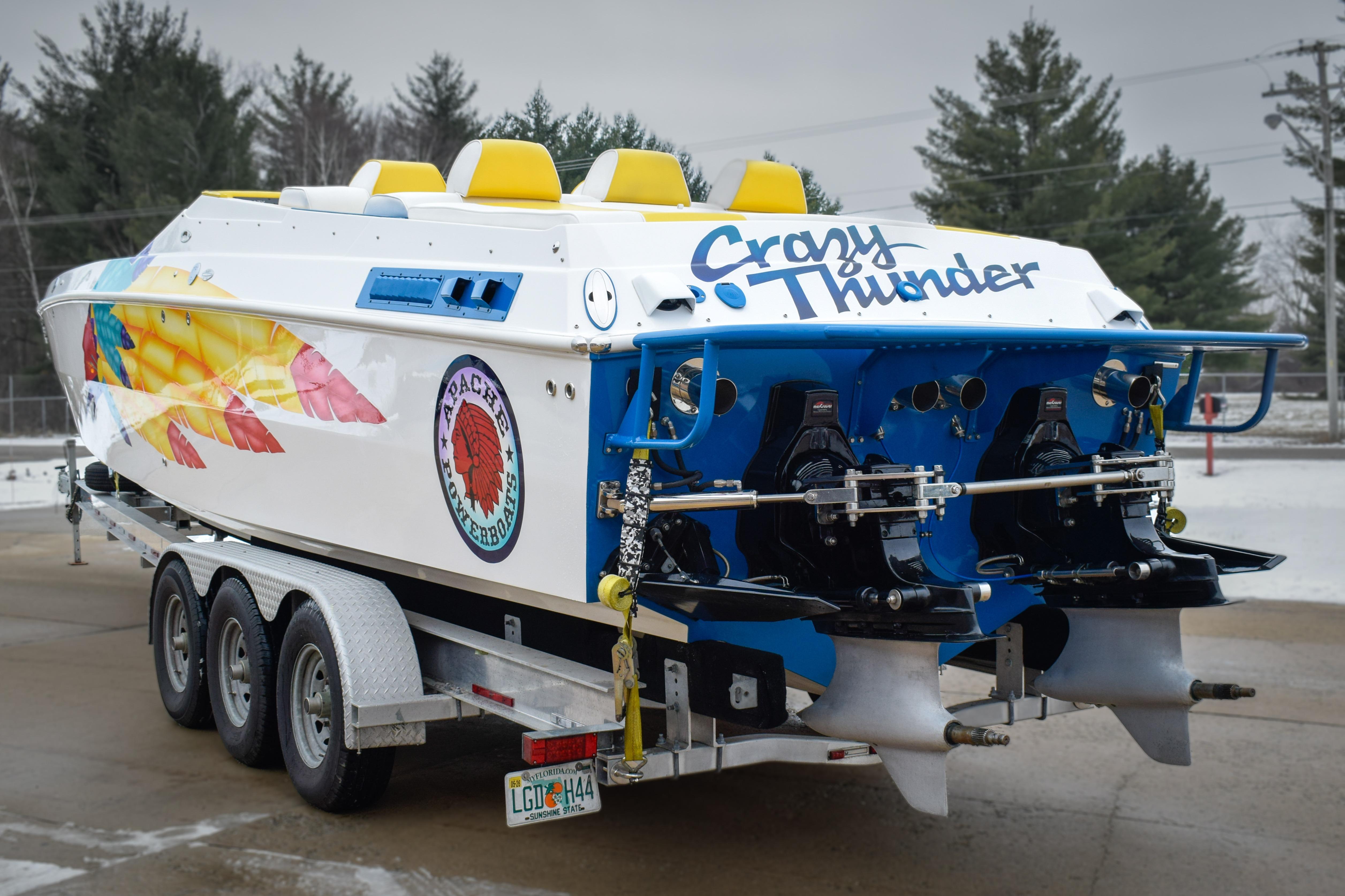 1998 Apache 36 WARRIOR speedboat on trailer, vibrant graphics, "Crazy Thunder" text.