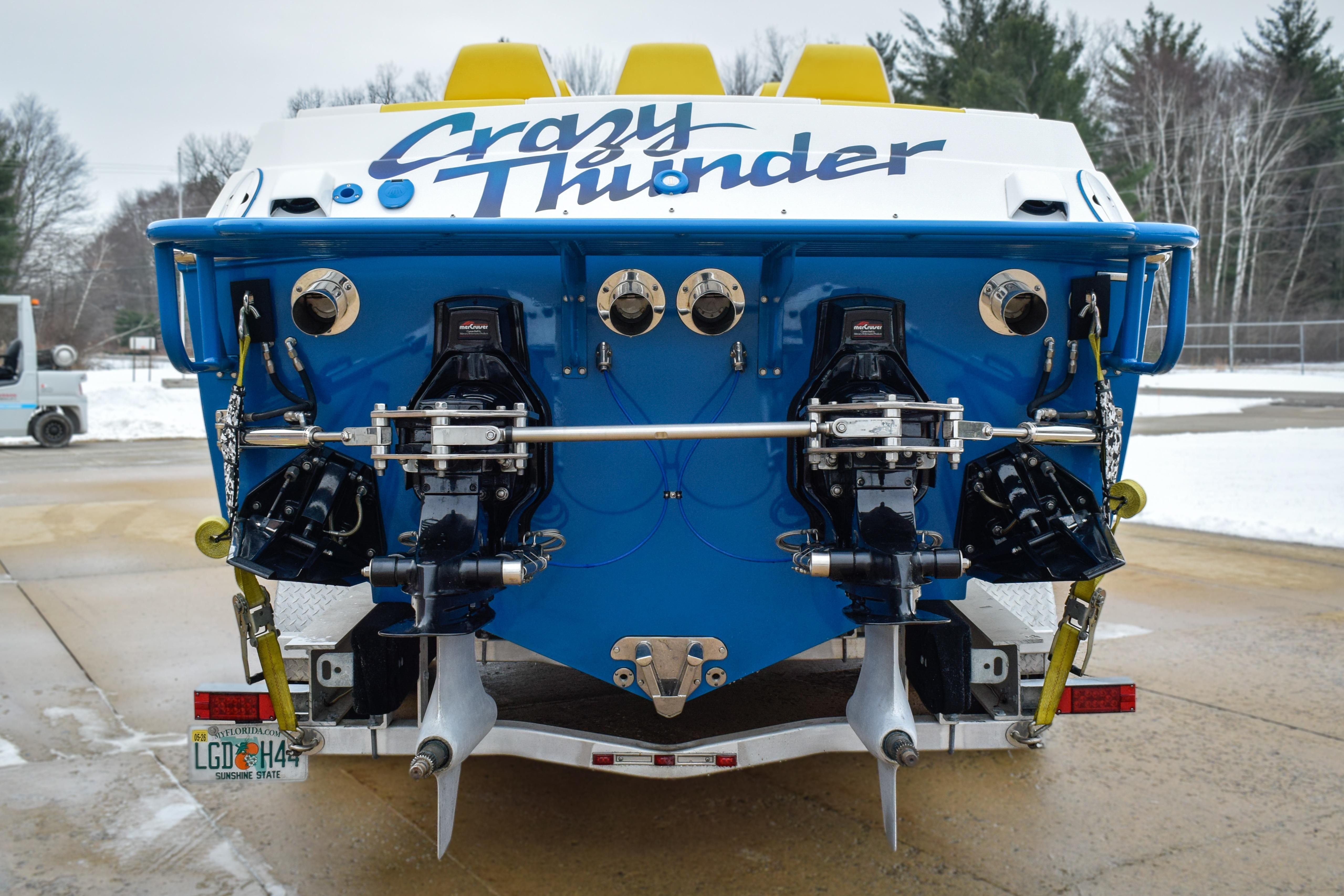 1998 Apache 36 WARRIOR boat, rear view, blue and white, "Crazy Thunder" text.