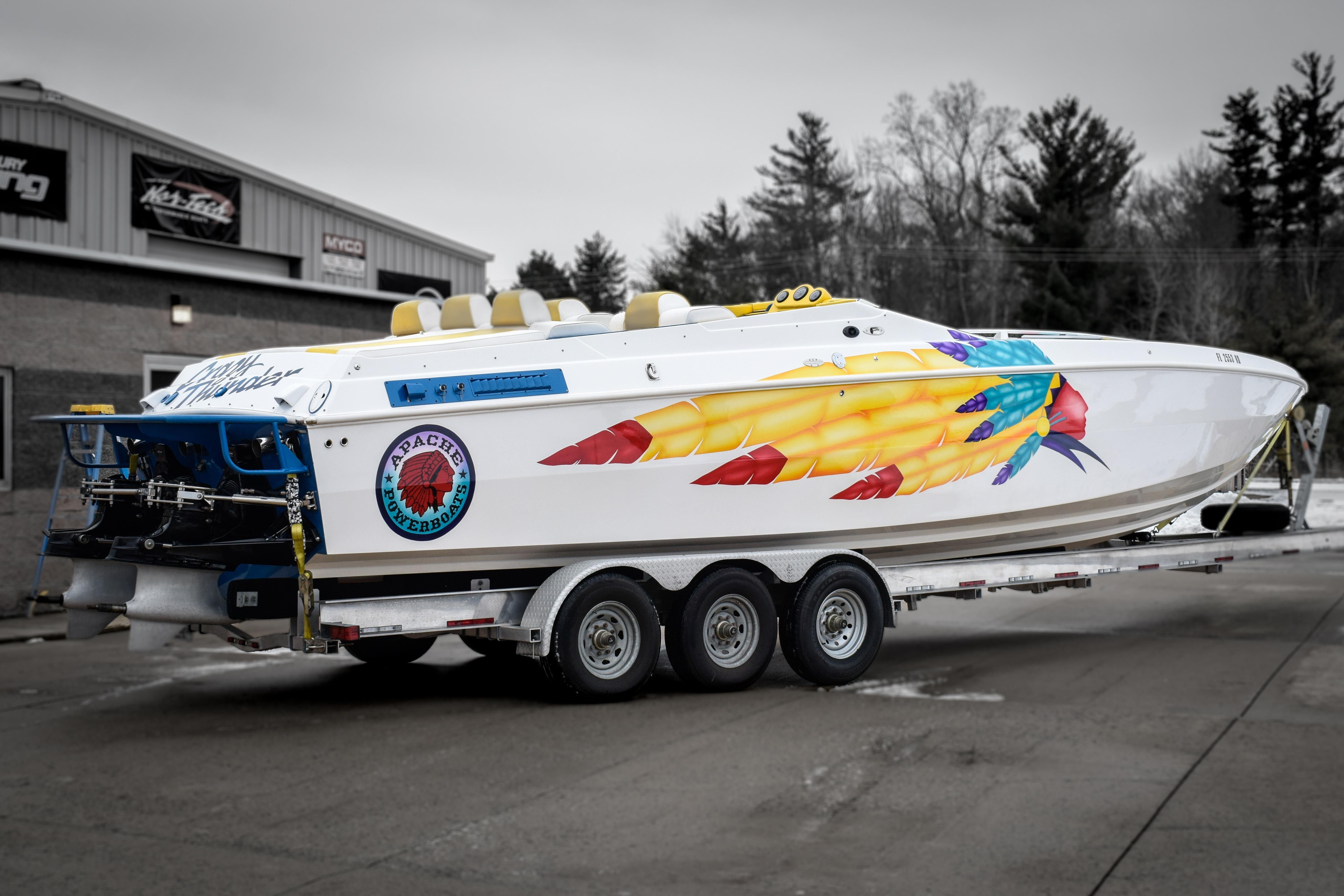 1998 Apache 36 WARRIOR powerboat with vibrant graphics on a trailer.