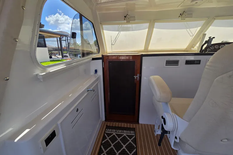 Lady Elizabeth Yacht Photos Pics Interior of 2006 Huckins Atlantic 44 yacht with helm seat and large windows.