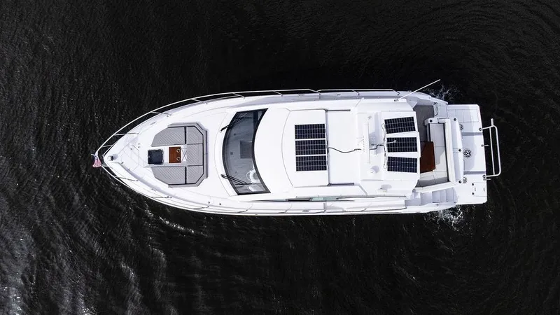  Yacht Photos Pics Top view of 2023 Cruisers Yachts 46 Cantius on water, showcasing sleek design and solar panels.