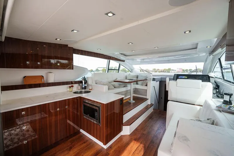  Yacht Photos Pics Luxurious interior of 2023 Cruisers Yachts 46 Cantius with modern kitchen and seating area.