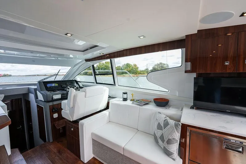  Yacht Photos Pics Luxurious interior of 2023 Cruisers Yachts 46 Cantius with modern helm and seating area.