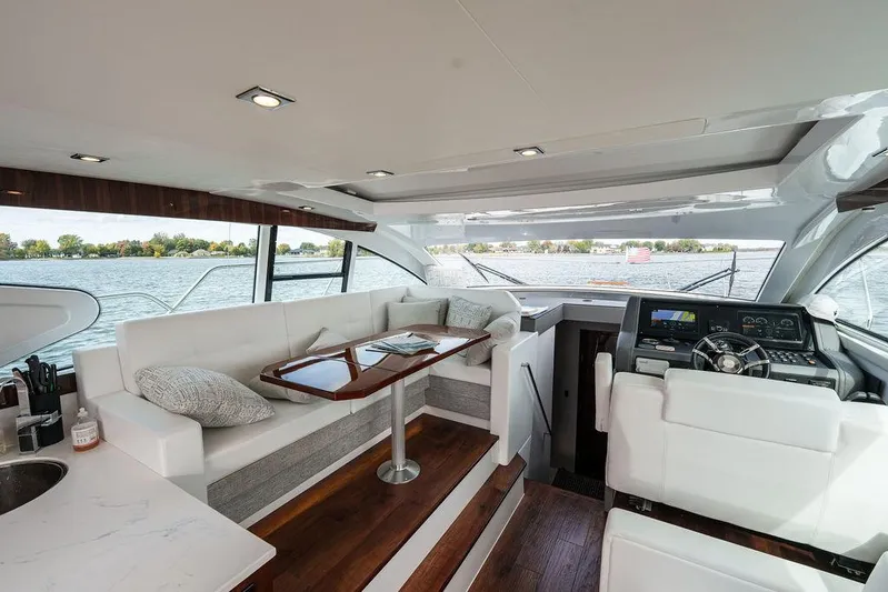  Yacht Photos Pics Luxurious interior of 2023 Cruisers Yachts 46 Cantius with elegant seating and modern helm.
