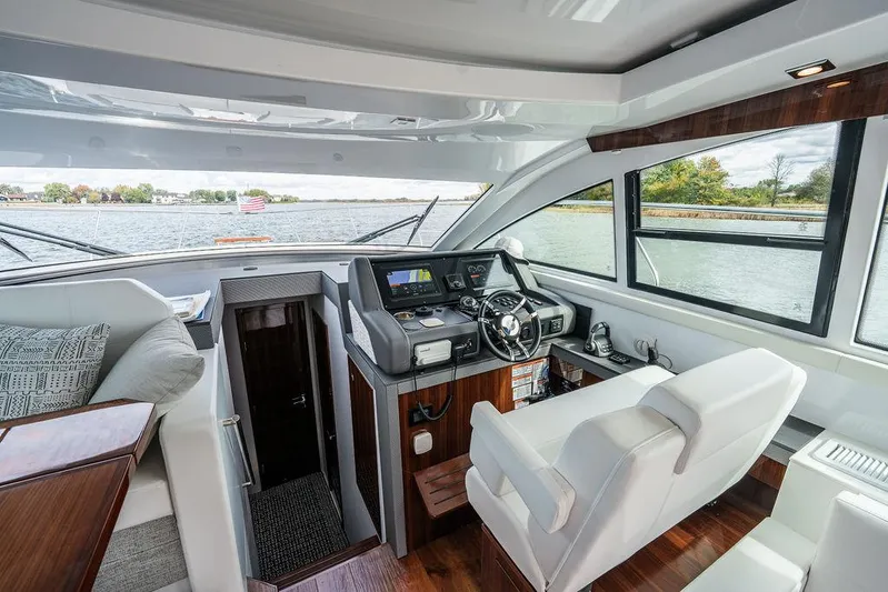 Yacht Photos Pics 2023 Cruisers Yachts 46 Cantius interior with modern helm, luxurious seating, and panoramic windows.