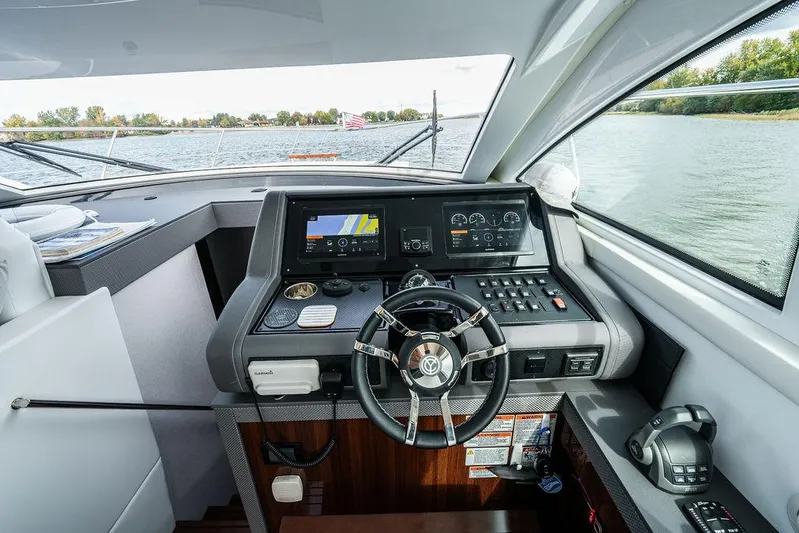  Yacht Photos Pics 2023 Cruisers Yachts 46 Cantius helm with advanced navigation system and luxurious interior.