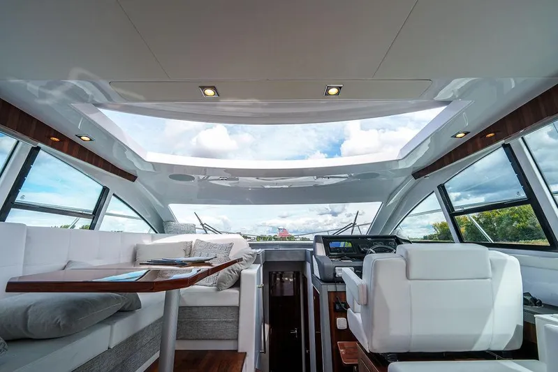  Yacht Photos Pics Luxurious interior of 2023 Cruisers Yachts 46 Cantius with panoramic windows and plush seating.