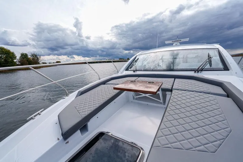  Yacht Photos Pics 2023 Cruisers Yachts 46 Cantius on water, featuring spacious deck and seating area.