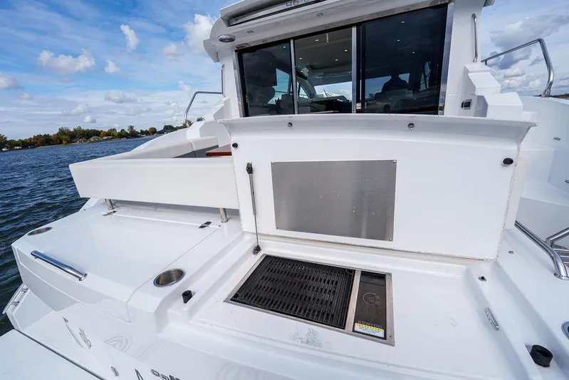  Yacht Photos Pics 2023 Cruisers Yachts 46 Cantius, rear deck view with water backdrop.