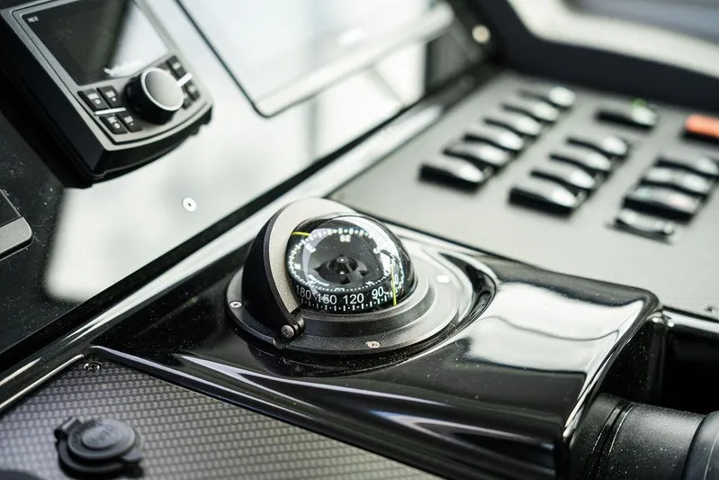  Yacht Photos Pics Control panel of 2023 Cruisers Yachts 46 Cantius with compass and navigation equipment.