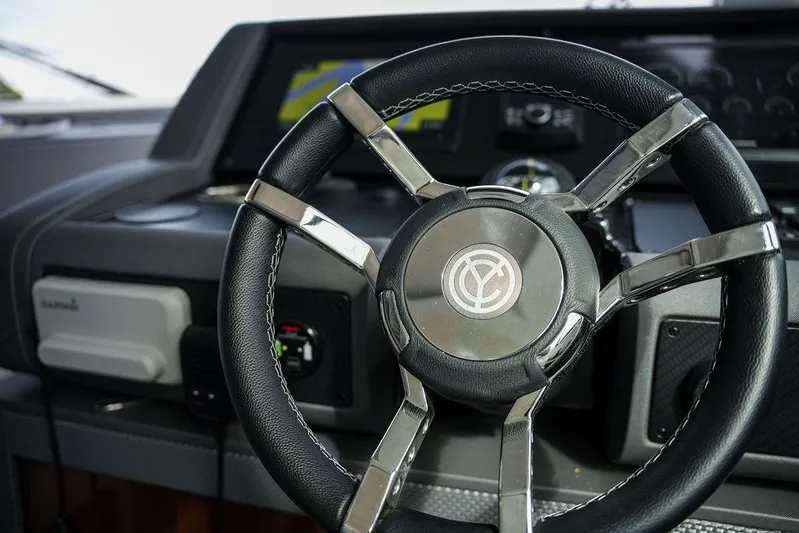  Yacht Photos Pics Steering wheel of 2023 Cruisers Yachts 46 Cantius, featuring modern dashboard controls.