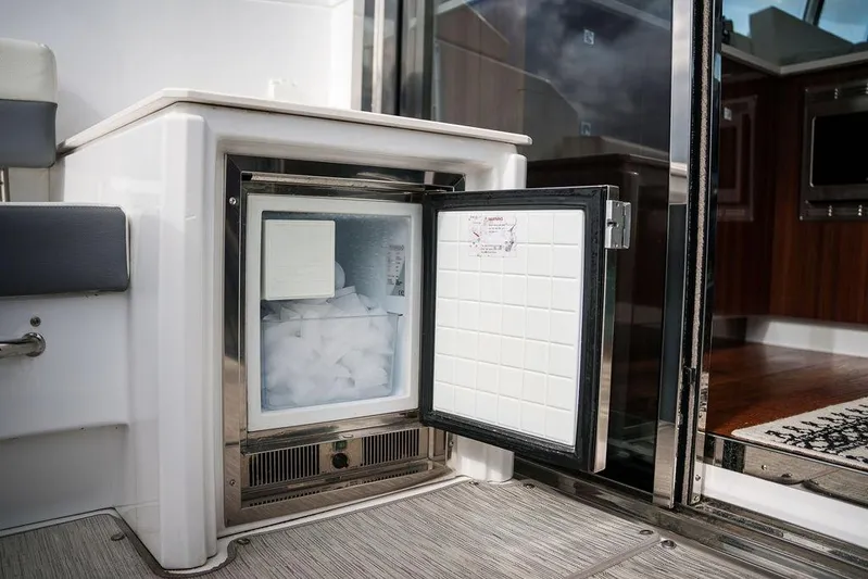  Yacht Photos Pics 2023 Cruisers Yachts 46 Cantius with open onboard freezer, showcasing interior ice storage.