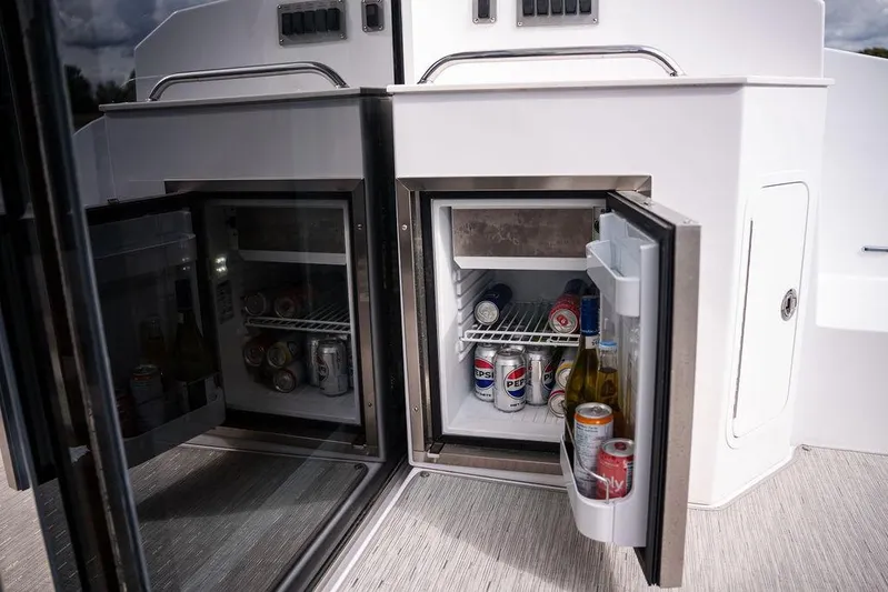  Yacht Photos Pics 2023 Cruisers Yachts 46 Cantius with open mini-fridges stocked with beverages.