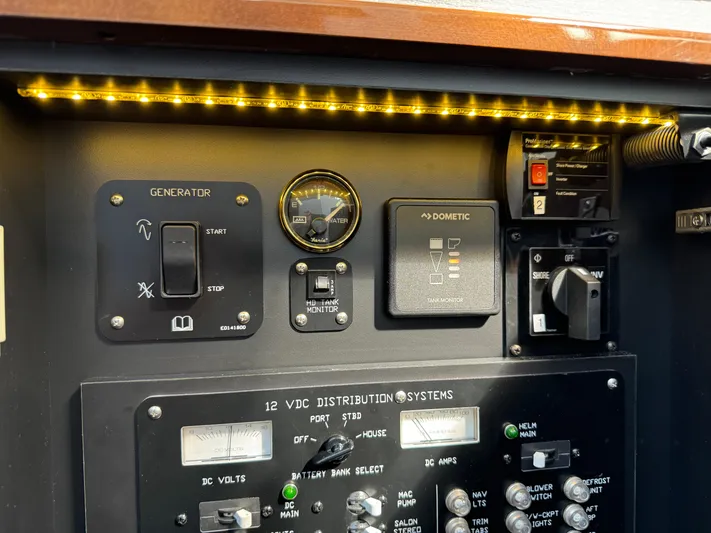  Yacht Photos Pics Electrical control panel of 2023 Cruisers Yachts 46 Cantius with illuminated switches and gauges.