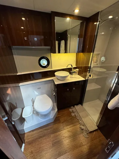  Yacht Photos Pics Luxurious bathroom in 2023 Cruisers Yachts 46 Cantius with modern fixtures and wood accents.