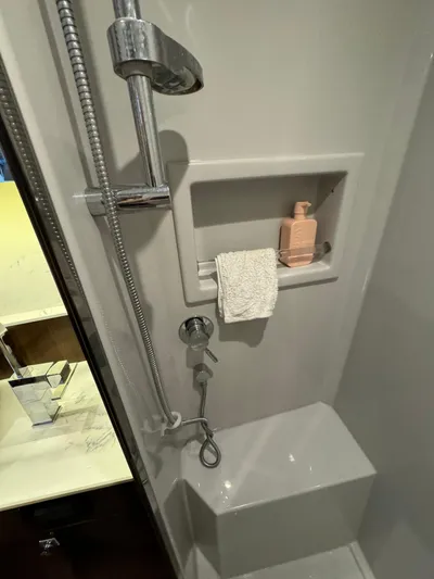  Yacht Photos Pics Shower area in 2023 Cruisers Yachts 46 Cantius, featuring modern fixtures and built-in shelf.