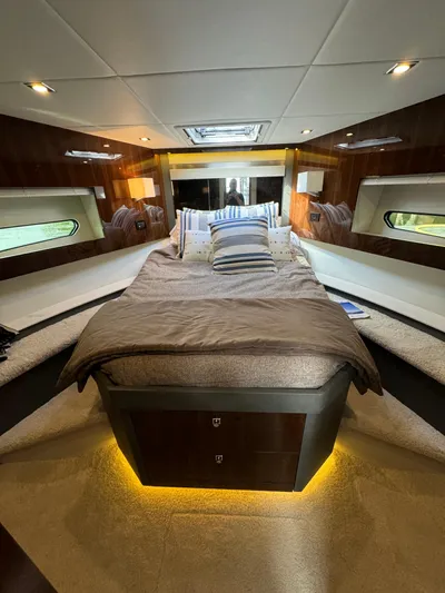  Yacht Photos Pics Luxurious interior of 2023 Cruisers Yachts 46 Cantius with elegant bedding and ambient lighting.