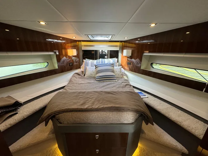  Yacht Photos Pics Luxurious 2023 Cruisers Yachts 46 Cantius cabin interior with cozy bed and elegant lighting.