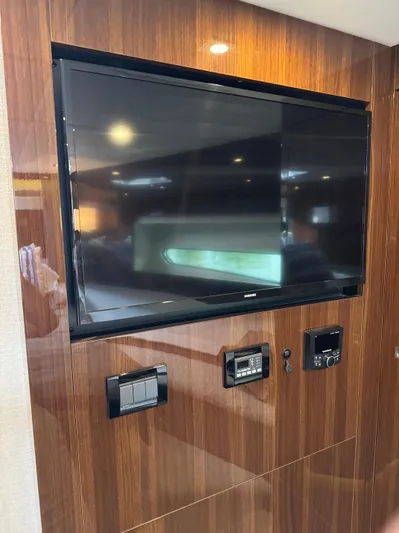  Yacht Photos Pics 2023 Cruisers Yachts 46 Cantius interior with wall-mounted TV and control panels.