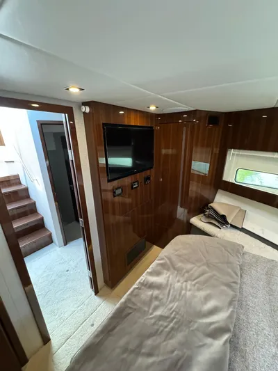  Yacht Photos Pics 2023 Cruisers Yachts 46 Cantius cabin interior with wood paneling and modern amenities.