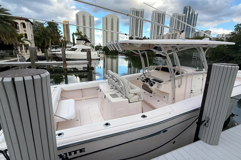  Yacht Photos Pics 2010 Grady-White Canyon 336 boat docked in a marina with city skyline backdrop.