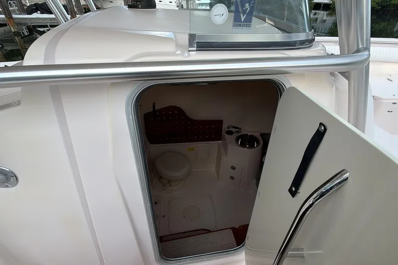  Yacht Photos Pics 2010 Grady-White Canyon 336 boat interior with open door revealing compact restroom.