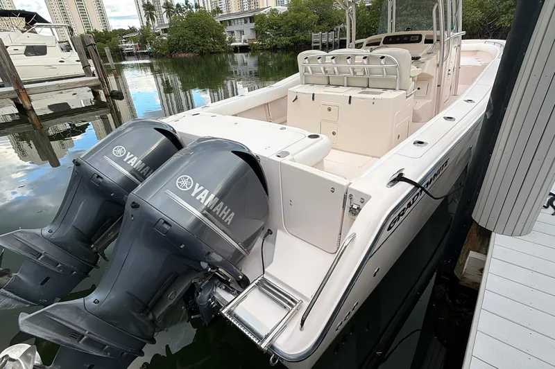  Yacht Photos Pics 2010 Grady-White Canyon 336 boat with dual Yamaha outboard engines docked by the water.