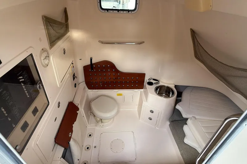  Yacht Photos Pics 2010 Grady-White Canyon 336 cabin interior with toilet, sink, and seating area.