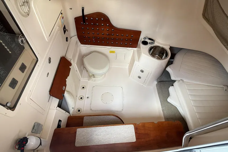  Yacht Photos Pics 2010 Grady-White Canyon 336 cabin interior with toilet, sink, and seating area.