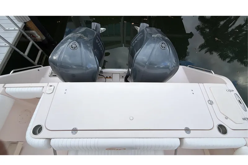  Yacht Photos Pics 2010 Grady-White Canyon 336 boat with dual outboard engines, docked by the water.