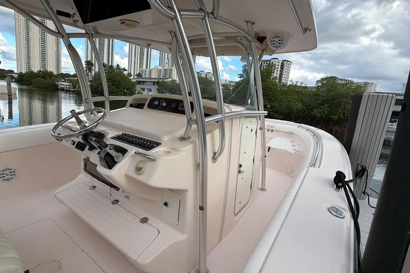  Yacht Photos Pics 2010 Grady-White Canyon 336 boat interior with steering console, docked near high-rise buildings.