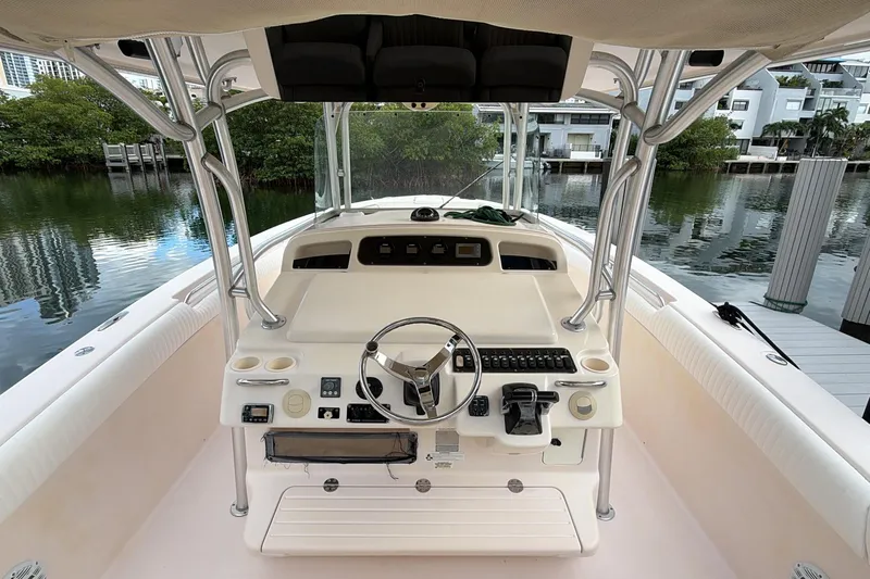  Yacht Photos Pics 2010 Grady-White Canyon 336 boat helm with steering wheel and controls, docked by water.