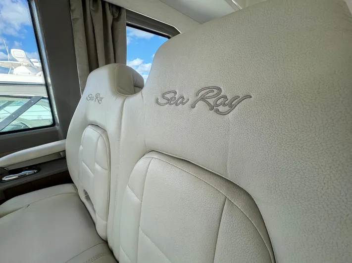  Yacht Photos Pics Luxurious interior seating of 2017 Sea Ray Sundancer yacht, featuring embroidered branding.