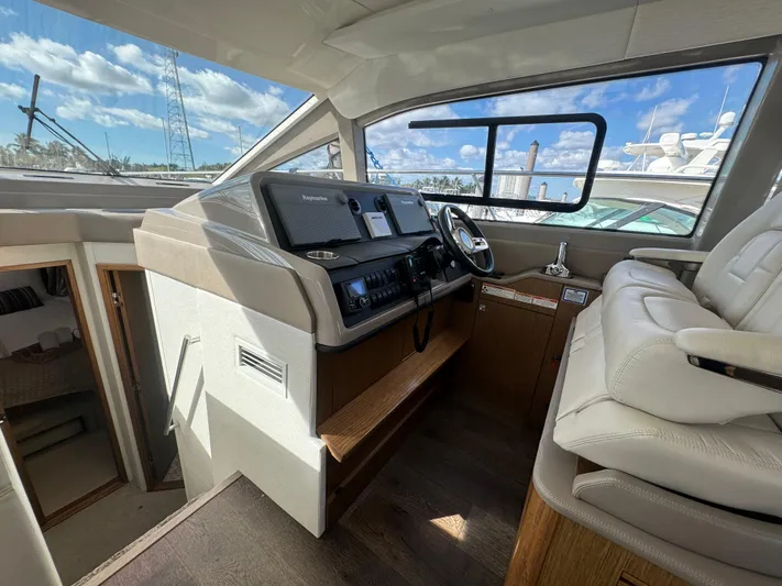  Yacht Photos Pics Interior view of 2017 Sea Ray Sundancer yacht cockpit with modern controls and seating.