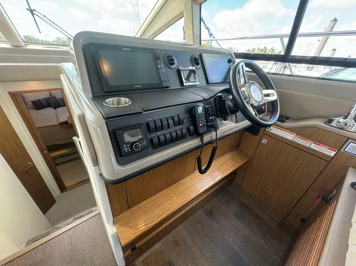  Yacht Photos Pics 2017 Sea Ray Sundancer helm with modern navigation equipment and wooden interior finish.