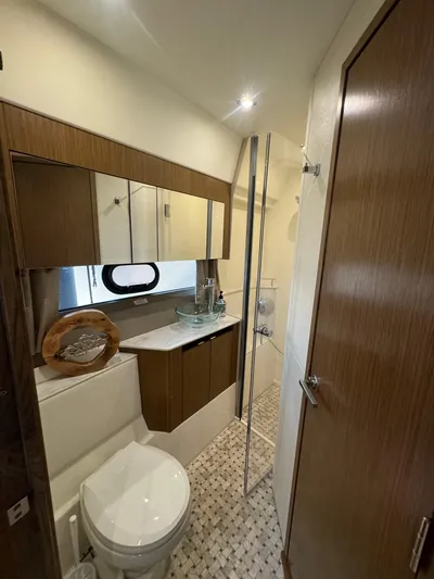  Yacht Photos Pics Luxurious bathroom in 2017 Sea Ray Sundancer yacht with modern fixtures and elegant wood finishes.