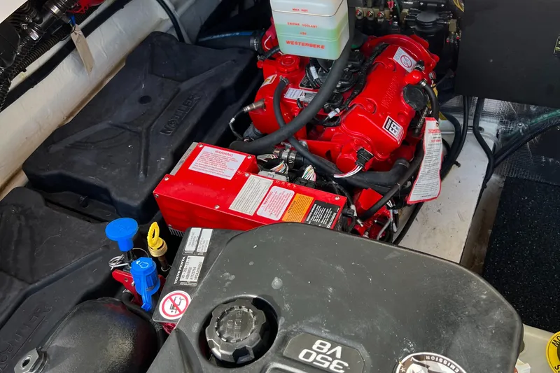 Y Knot Yacht Photos Pics Engine compartment of a 2021 Regal 36 Grande Coupe, featuring red and black components.