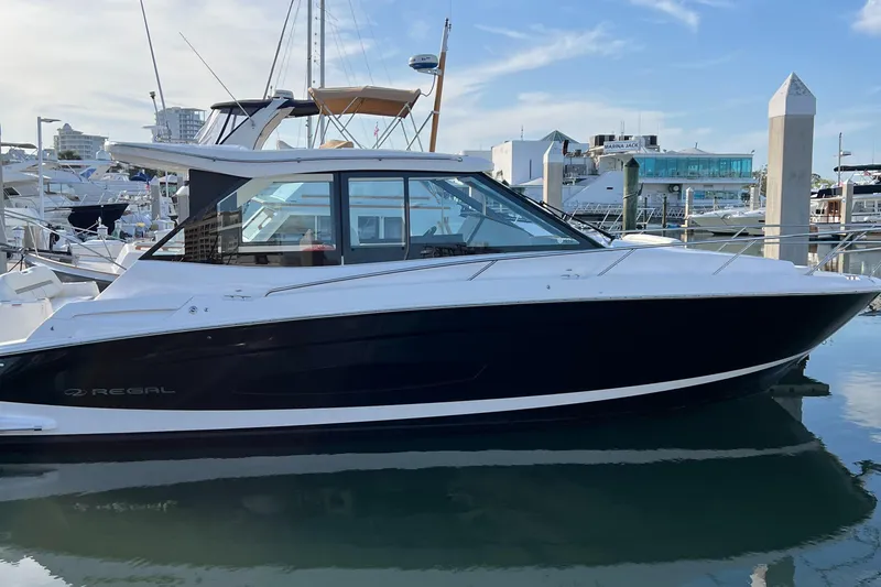 Y Knot Yacht Photos Pics 2021 Regal 36 Grande Coupe yacht docked in marina, side view.