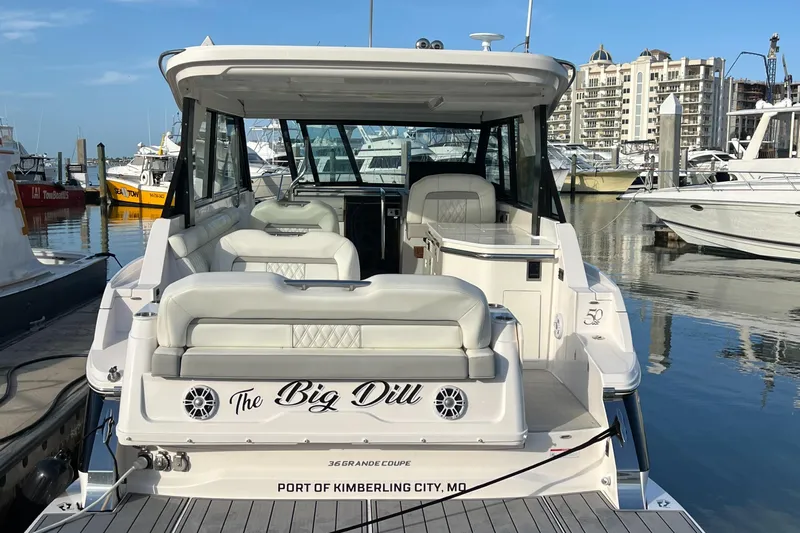 Y Knot Yacht Photos Pics 2021 Regal 36 Grande Coupe docked at marina, featuring spacious seating and modern design.