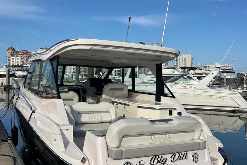 Y Knot Yacht Photos Pics 2021 Regal 36 Grande Coupe yacht docked at marina, featuring spacious seating and sleek design.