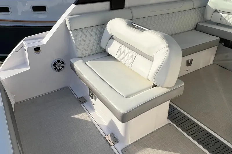 Y Knot Yacht Photos Pics Luxurious seating on 2021 Regal 36 Grande Coupe boat, featuring elegant white upholstery.