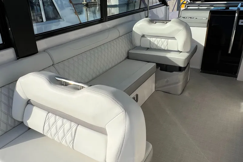 Y Knot Yacht Photos Pics Luxurious interior of 2021 Regal 36 Grande Coupe with elegant white seating.