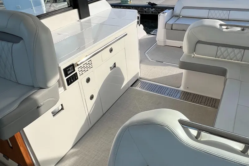 Y Knot Yacht Photos Pics Interior of 2021 Regal 36 Grande Coupe, featuring sleek seating and modern cabinetry.