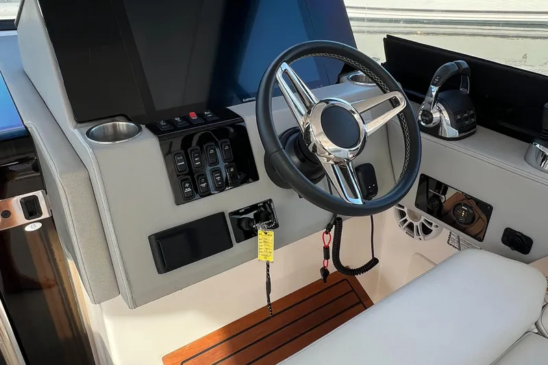 Y Knot Yacht Photos Pics 2021 Regal 36 Grande Coupe helm with modern controls and sleek steering wheel.